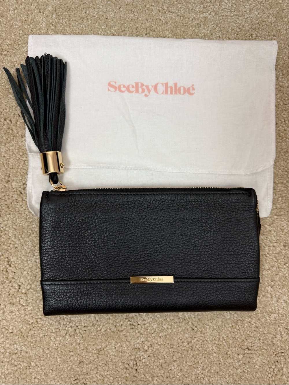 SEE BY CHLOE | black pebbled leather zip wallet clutch with tassel